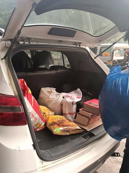 Loading my car with supplies for distribution. My social responsibility initiatives are a core part of who I am.