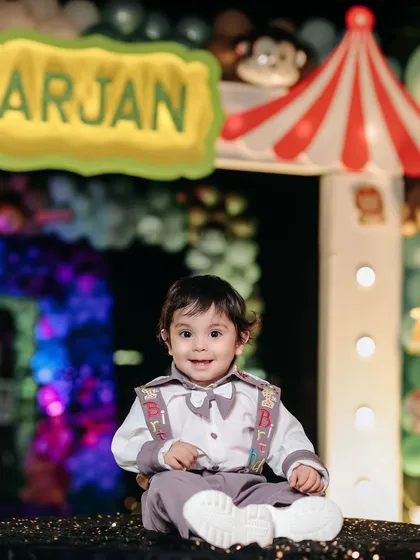 A bright and happy smile from the birthday boy. This photo perfectly captures the fun and excitement of his special day.