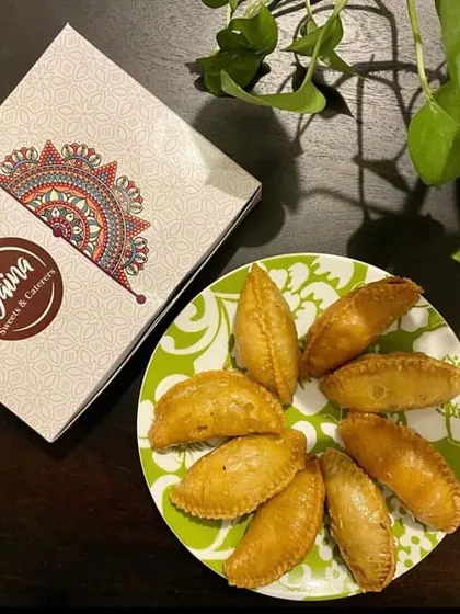 Our delicious, crispy Gujiyas served fresh and ready to be enjoyed. They come packed in our signature boxes, making them a great Holi gift.