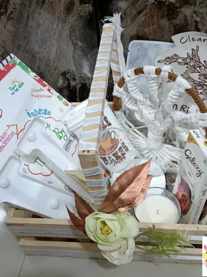 A still shot of the elegant white-themed hamper, showcasing all the curated items together in a rustic wooden crate.