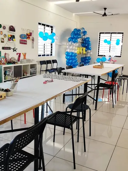 Another view of our studio prepared for a birthday party, with blue balloon decorations and all the art stations set up for the kids.
