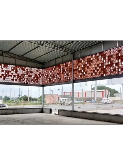 Looking from within the warehouse, our custom terracotta jali screen filters daylight and provides ventilation. This showcases how we design elements that are both functional and create a unique spatial experience for those inside.