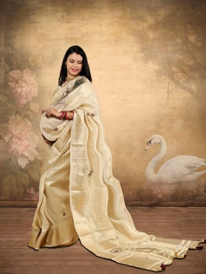 A beautiful expecting mother in a flowing cream-colored saree. My sister's editing adds a painted effect with a swan, turning a simple photo into a piece of art.