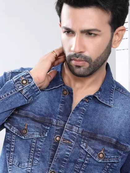 A model looking stylish in a classic denim jacket. The focus on the texture and fit of the jacket makes this a great shot for a casual wear or denim brand.