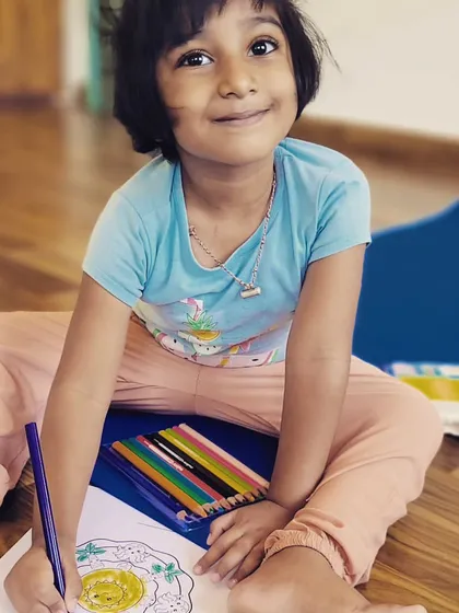 The smile of a happy yogi. After our practice, this little one is enjoying a quiet moment of creativity, coloring a mandala. Mindfulness can be found in many forms.