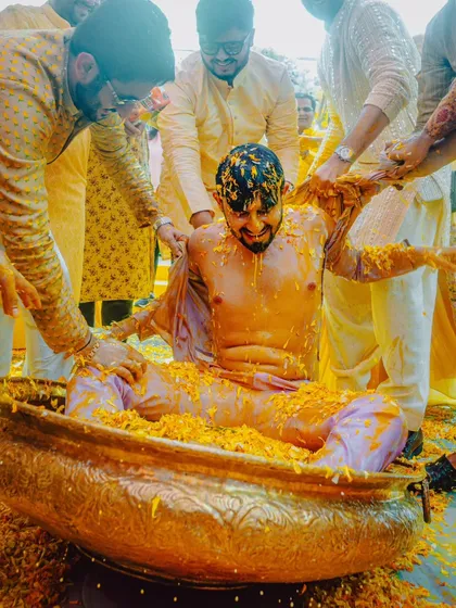 When the Haldi turns into a full-blown party. We're right there in the middle of the action to capture the groom being playfully doused by his friends and family.