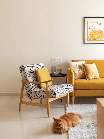 Another shot of the living room, with Penny the cat enjoying the cozy rug. The space is designed to be a comfortable and happy home for all its inhabitants.