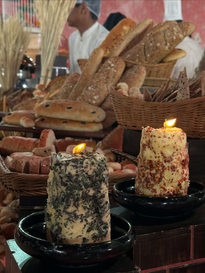 Our innovative edible cheese candles. These are blocks of herbed butter and cheese with a wick that can be lit, melting the cheese for guests to spread on fresh bread.