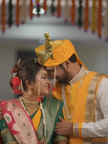 An intimate portrait of a couple during their traditional Maharashtrian wedding, their foreheads touching in a moment of quiet connection.