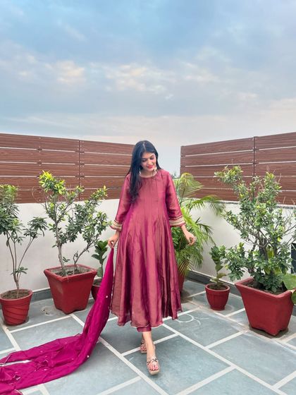 A simple yet elegant anarkali in a beautiful wine color. The long, flowing silhouette is universally flattering and perfect for any formal occasion.