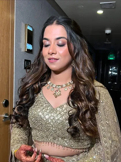 A serene shot with eyes closed, highlighting the beautiful golden shimmer on her eyelids.