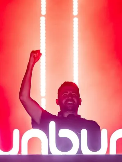 Dimitri Vegas celebrating behind the iconic Sunburn logo after a killer set.