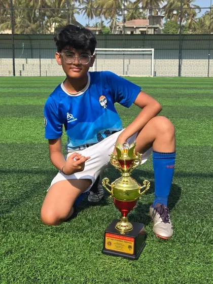 A confident pose from a U14 champion with his trophy.