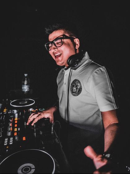 A candid, happy moment during a set at The Game Palacio. The dark lighting puts all the focus on the music.