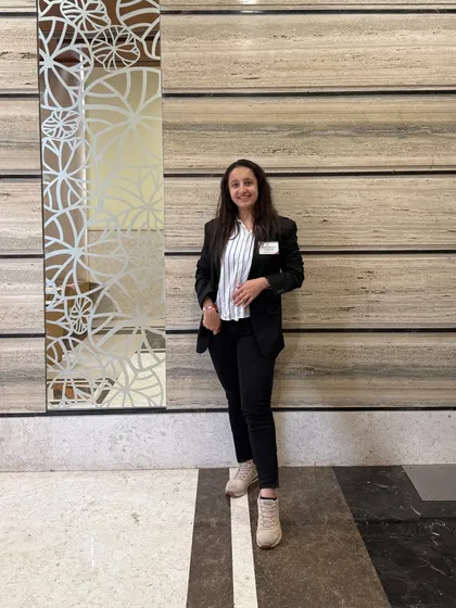 A smiling, confident pose in my professional attire. I bring the same energy to my business as I do to my dance.