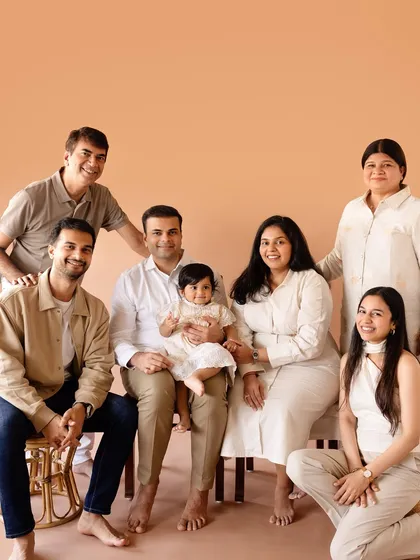 A full extended family portrait against a warm, neutral backdrop in the studio. We love capturing multiple generations in one frame.