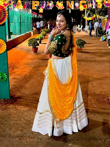 Dressed and ready for a Garba night. I don't just teach the steps; I live the festive vibe, helping you create an authentic and colorful Navratri celebration with traditional attire and music.
