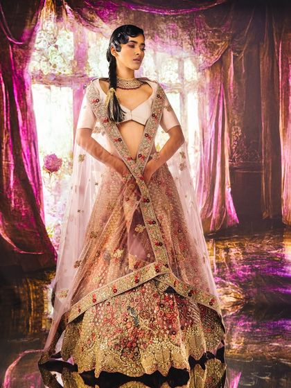 A grand, sunlit room with pink curtains and marble floors, created with projection. The setting provides a regal and romantic atmosphere for this stunning bridal lehenga.