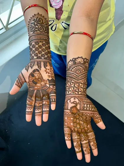 A view of both hands together, showing the complete story of Savitri and Satyavan for the festival.