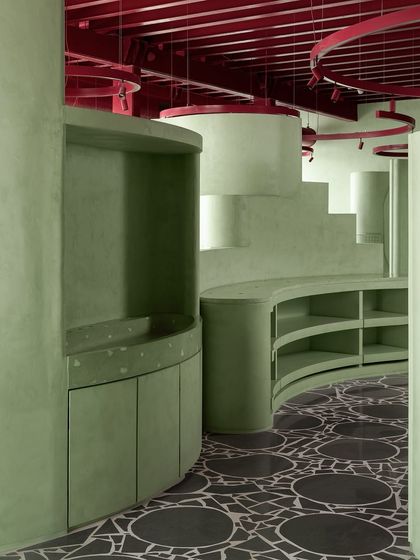 A look at the curved shelving units sitting atop our custom terrazzo floor, showing how different design elements can work in harmony.