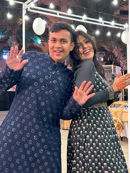 A guest at a destination wedding in Bahrain, wearing our deep navy blue kurta with intricate mirror work embroidery. An exquisite choice for an enchanting Sufi night.