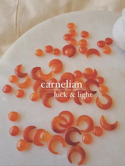 Two crystals for luck: peach moonstone for good fortune in love, and carnelian for prosperity and light.