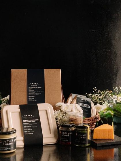 A beautifully arranged Father's Day gift featuring our truffle and parmesan hummus, basil pesto, and a selection of cheeses and breads. It’s a sophisticated gift for the dad who appreciates fine food.