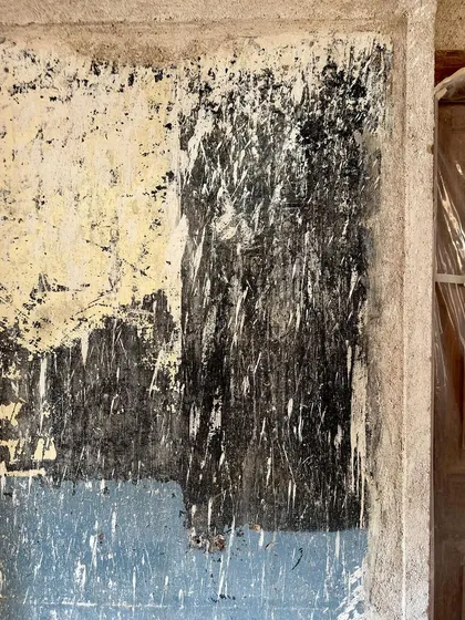 The abstract patterns created by stripping old paint from a wall. We see these surfaces as historical documents, revealing clues about past uses and finishes.