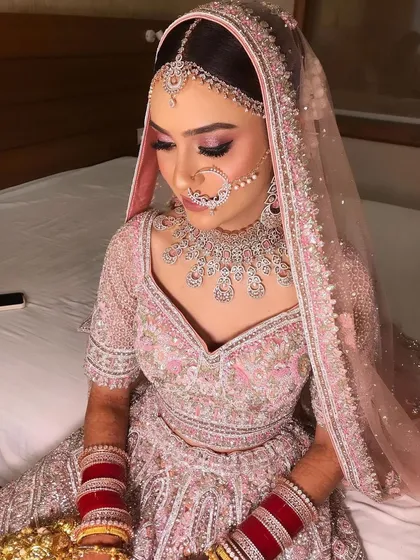 A bride in pink is always a beautiful sight. I created a soft, romantic look with pink shimmery eyes for her pastel lehenga.