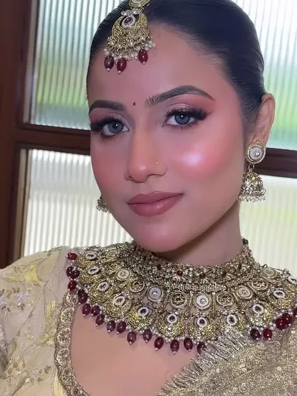A close-up of the masterclass bridal look. You can see the flawless base, the precise eye makeup, and the beautiful jewelry pairing.
