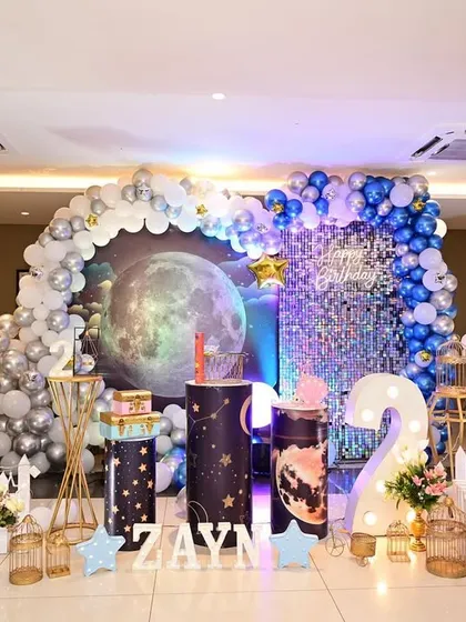 I can bring any universe to your celebration. This star and moon themed party features a galaxy backdrop with a balloon arch, a sequin wall for extra sparkle, and themed props that make the event feel out of this world.