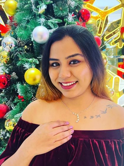 A joyful holiday photo where I'm showcasing the Giva necklace, sharing a discount code to encourage my followers to shop the collection.