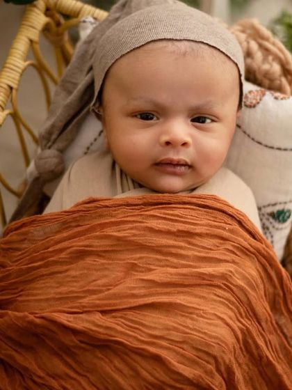 A moment of quiet alertness. It's so special when babies open their eyes during a session. This portrait captures his calm and curious gaze.