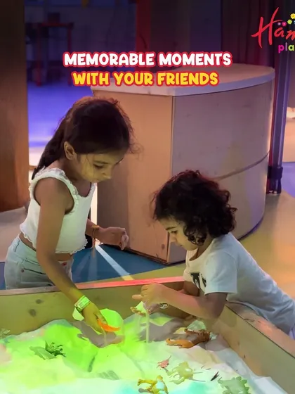 The best parties are about creating memorable moments with friends. Here, two children are engrossed in our interactive sand play table, one of the many activities available during our birthday celebrations.