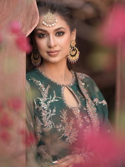 Golden glow, green dreams, and a whole lot of mehendi charm. This close-up shot shows the beautifully defined eye makeup that complements the traditional green outfit.