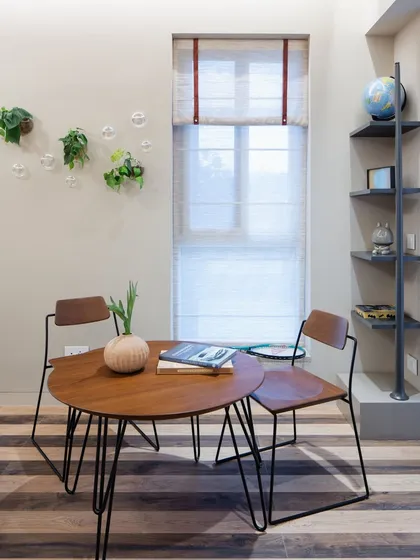 This compact workspace is perfect for a small apartment or a teenager's room. The striped flooring adds a playful touch, while the wall-mounted plants bring in a bit of greenery without taking up desk space.