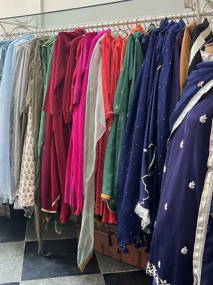 A rainbow of rich velvet and silk outfits on a rack. This is the kind of variety I look for when shopping for a winter wedding wardrobe.