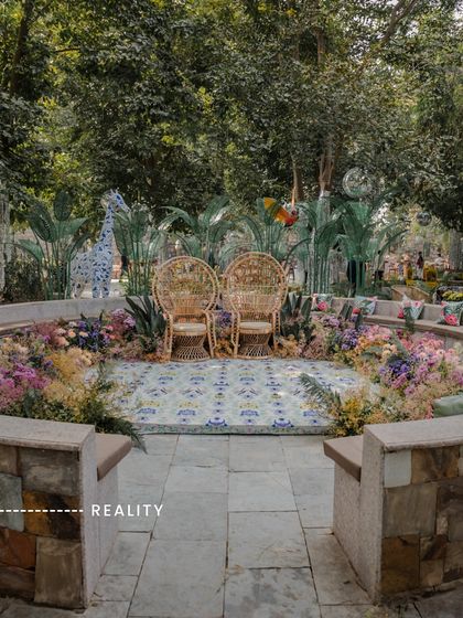 Reality: The jungle-themed Haldi comes to life. The wicker peacock chairs, vibrant floral arrangements, and custom-printed floor create an immersive, playful environment that perfectly captures the "spirit animal" theme.