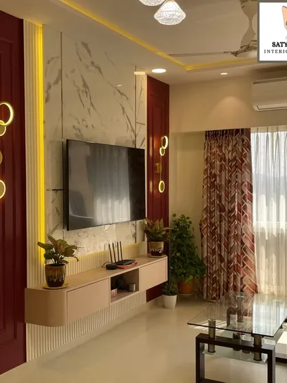 This TV unit design combines a bold red accent wall with a floating console and elegant lighting, creating a dramatic and stylish focal point.