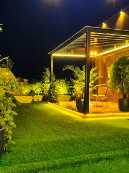A beautiful night shot of the Model Town terrace, with layered lighting creating depth and highlighting the different zones.