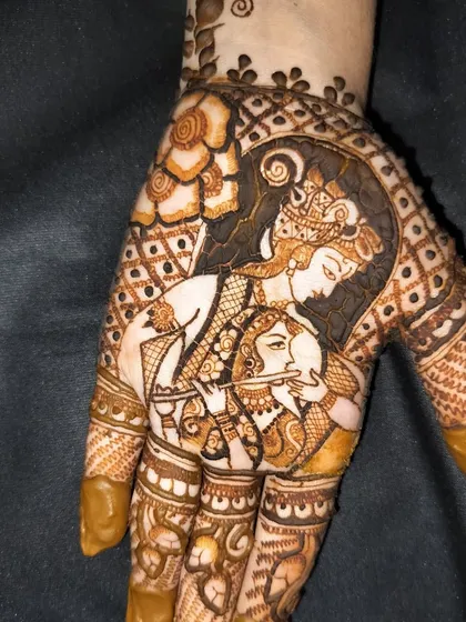 A detailed portrait of Radha and Krishna, perfect for a bride who wants to incorporate divine elements into her wedding mehndi.
