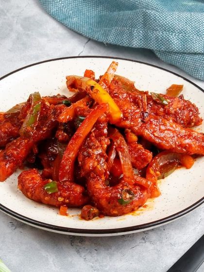 Our classic Chilli Chicken, featuring juicy chicken pieces stir-fried with colourful bell peppers and onions in a spicy, flavourful sauce.