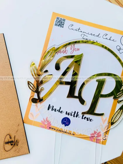 Another angle of the "AP #PRAMAR FOREVER" topper, showing its clarity and the elegant gold lettering.