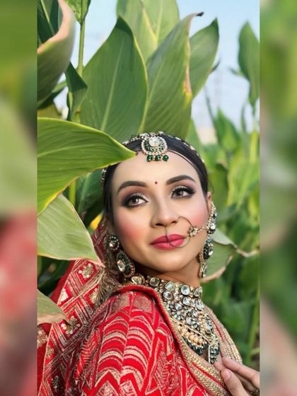 A creative shot of the bride peeking through leaves, adding an artistic touch to the portfolio.