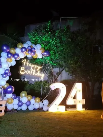 An outdoor nighttime setup for a 24th birthday. I used a balloon half-arch, a neon sign, and large '24' marquee numbers on the lawn.