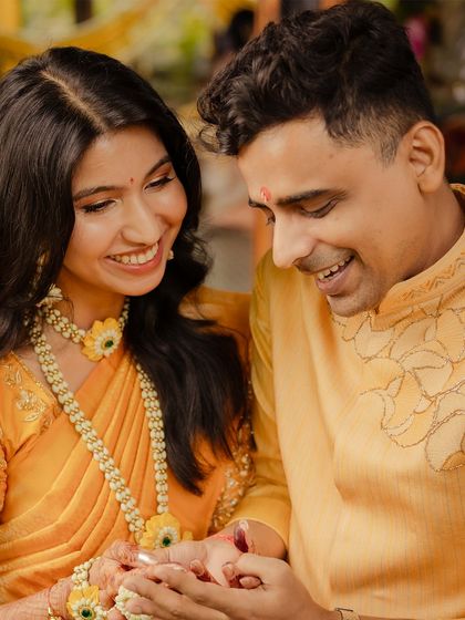 A vibrant yellow kurta with delicate, tonal embroidery for a Haldi ceremony. The design complements his bride's attire, creating a perfectly coordinated and joyful look for the celebration.
