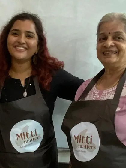 Posing with Vimala ma'am, wearing our Mitti Matters aprons. These workshops are built on the support of a strong, empowering community.