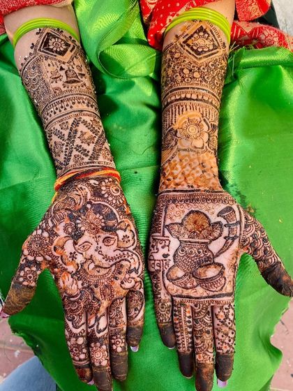 A festive design featuring a Ganesha motif on one hand and a kalash on the other. This is a perfect design for any auspicious occasion or puja.
