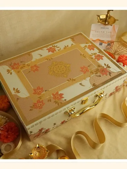 Embrace the purity of white for Navratri. This elegant floral suitcase box is perfect for gifting sweets and dry fruits as you transition into the Diwali season.