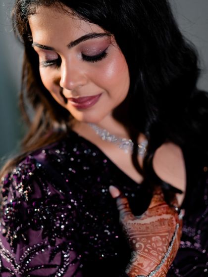 A beautiful close-up of the bride, her gentle smile and intricate henna and jewelry making for a stunning portrait.
